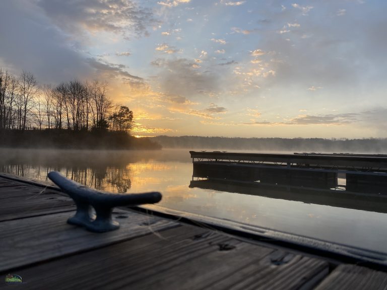 Image of a still lake on a crisp, misty fall morning