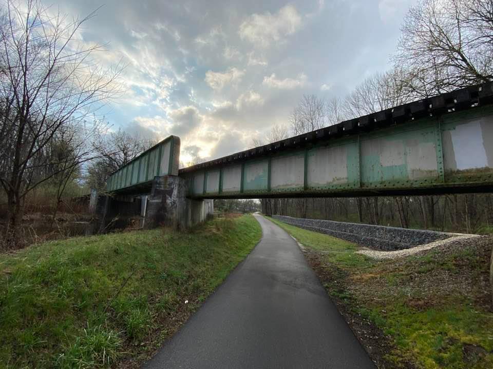 Towpath going under a metal bridge