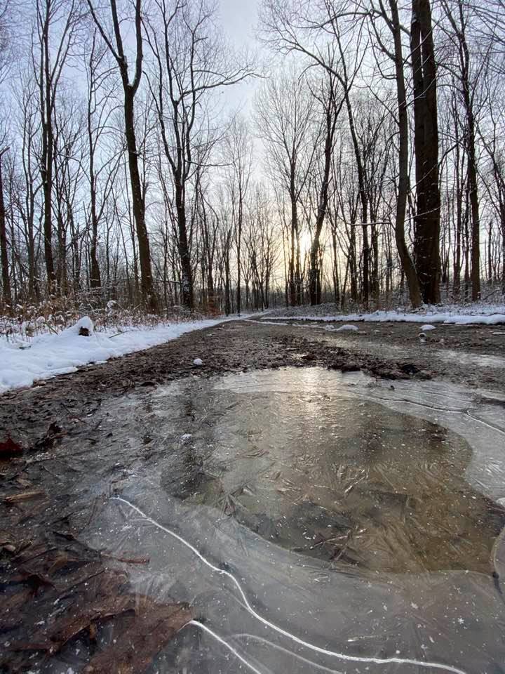 Sunrise reflecting on an icy puddle