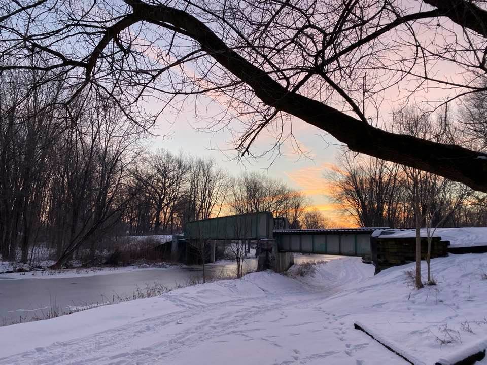 Railway bridge over the canal on a snowy morning