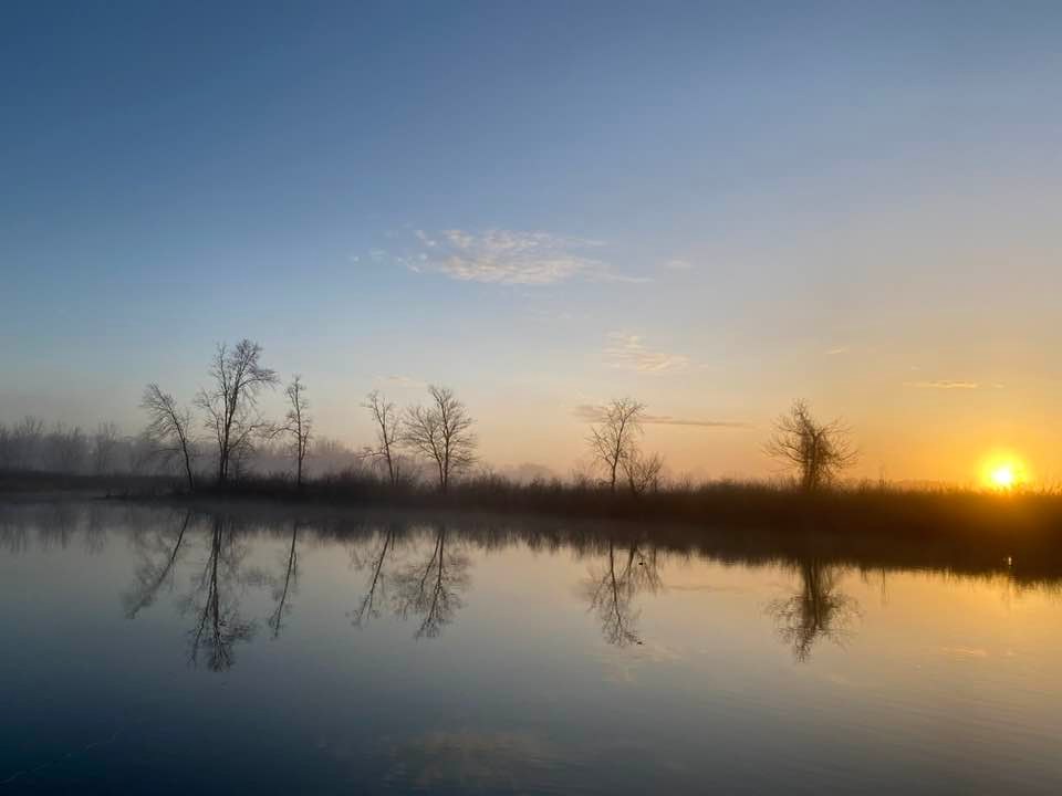 Sun coming up across the lake