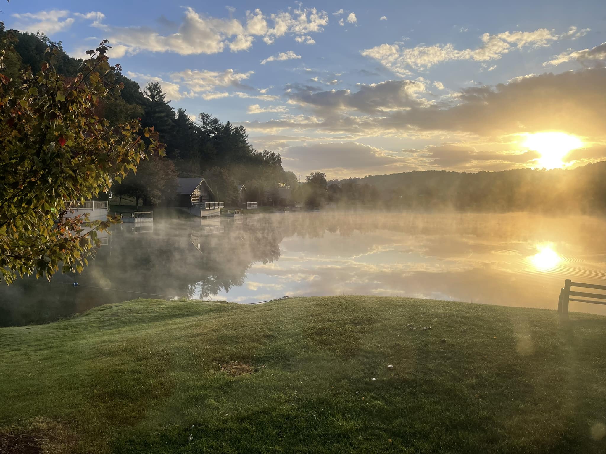 View across the lake at sunrise with mist rising