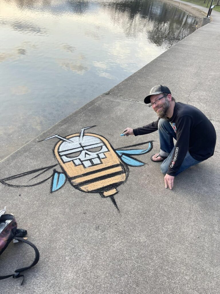 James and I went to Lake Anna in Barberton for our evening walk. We ran into this guy creating some pretty cool art on the sidewalk, we had to stop and take a picture! 🪲🛸