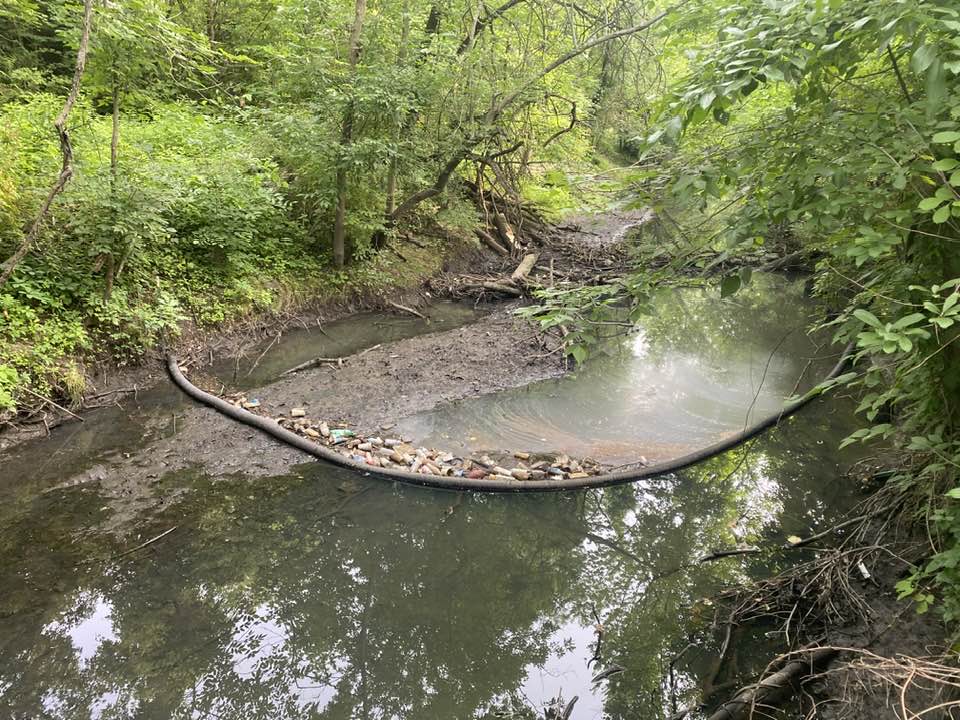 Boom on the river that has collected trash