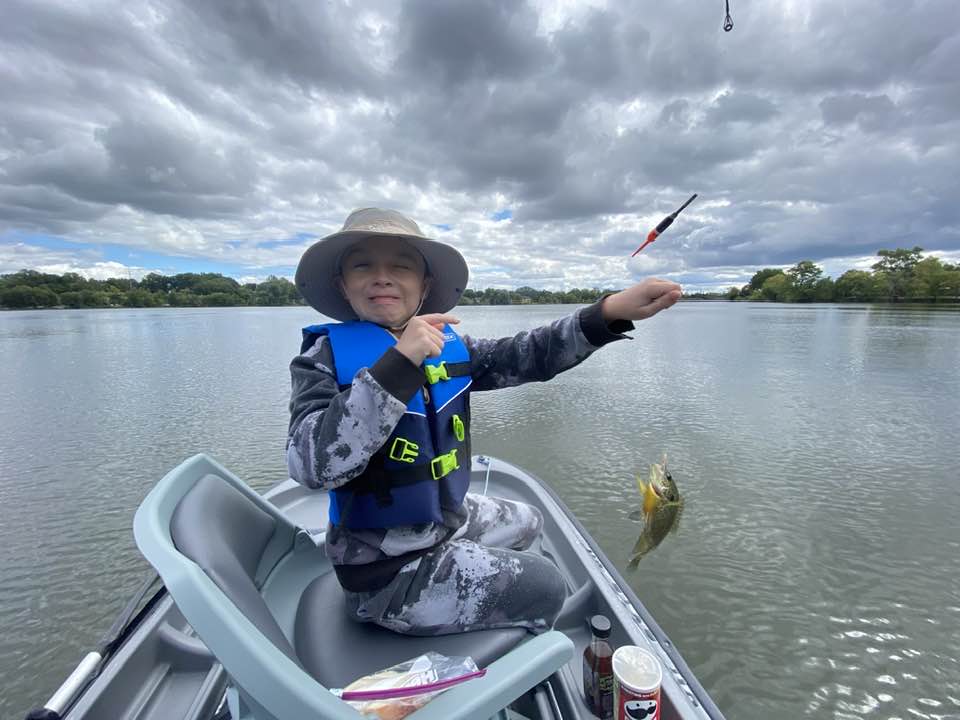 Boy in boat catching fish